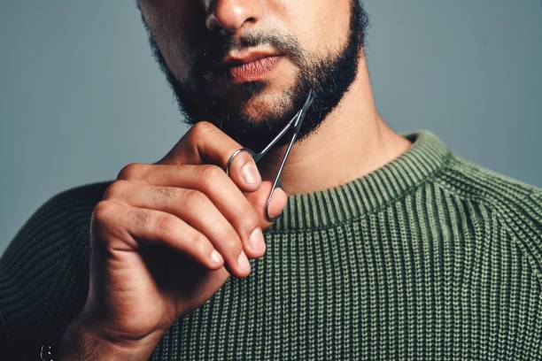 Maintaining shape and health by trimming your hair or beard while growing it out.